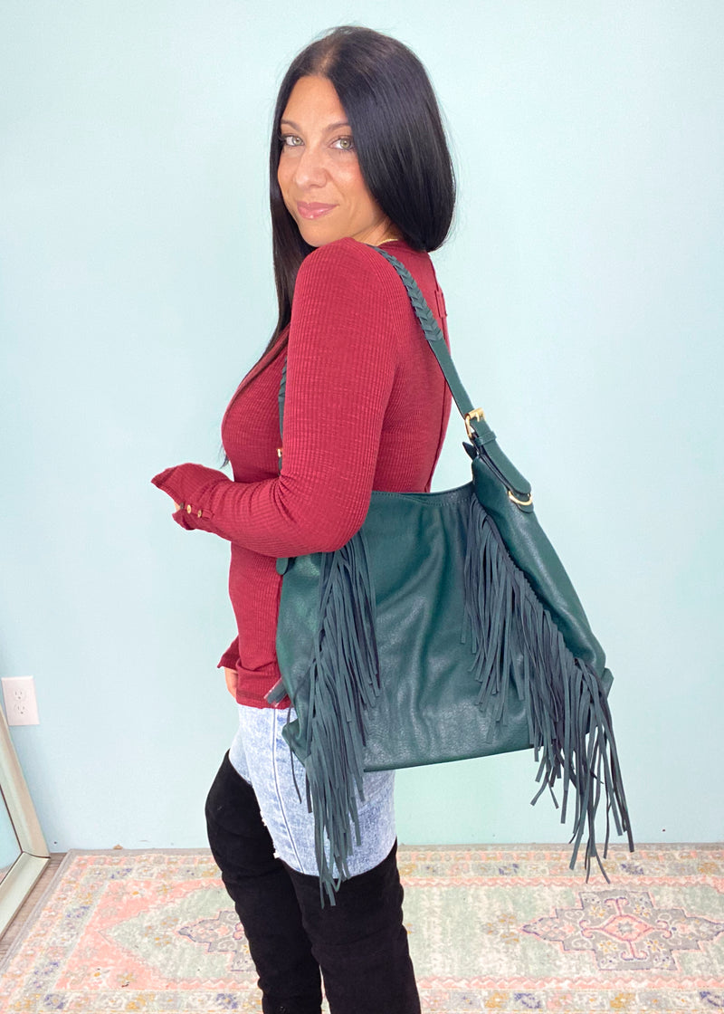 Peacock Green Distressed Faux Leather Fringe Detail Hobo Bag-This gorgeous peacock green slouchy hobo bag has a big city meets small town vibe! The luxurious soft faux leather has a vintage distressed feel and you will love every single detail on this including the braided strap and fringe details. An instant add to cart moment! -Cali Moon Boutique, Plainville Connecticut